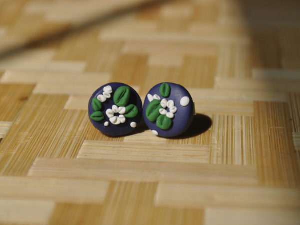round clay earrings with white flowers