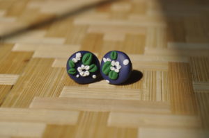 round clay earrings with white flowers